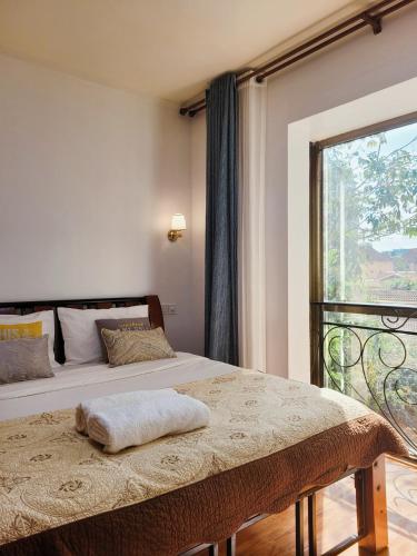 a bedroom with a bed and a large window at Stunning and serene homes in Nairobi