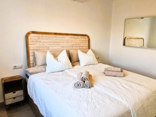 a bedroom with a large white bed with towels on it at Villa Panorama in Jávea