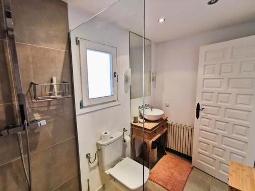 a bathroom with a toilet and a sink at Villa Panorama in Jávea