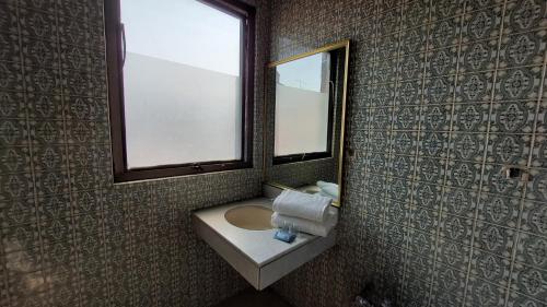a bathroom with a sink and a mirror at Residencias Señorial in Mexico City