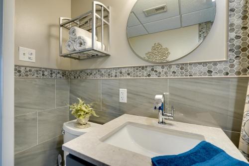 a bathroom with a sink and a mirror at Cozy Oceanfront Condo with Pool and Beach Access! in Wildwood Crest