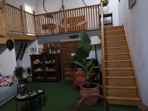 a living room with stairs and a potted plant at atmosphere in Poilhès