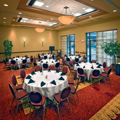 a conference room with tables and chairs in it at Embassy Suites East Peoria Hotel and Riverfront Conference Center in Peoria