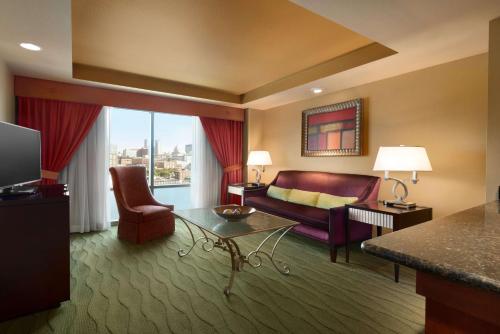 a living room with a couch and a table at Embassy Suites East Peoria Hotel and Riverfront Conference Center in Peoria