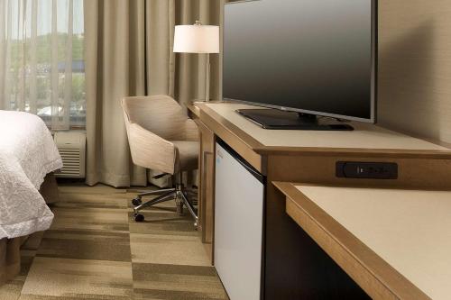 a hotel room with a television and a bed at Hampton Inn & Suites Baltimore North/Timonium, MD in Timonium