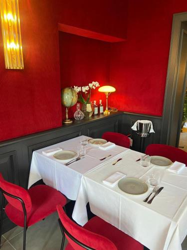a dining room with a white table and red walls at Le Funi Hotel in Bergamo