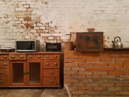 a kitchen with a microwave and a tv on a counter at Hip center basement studio in Vienna