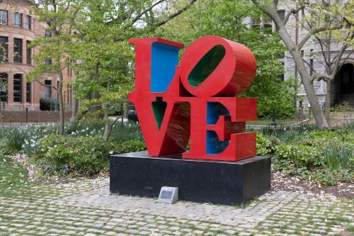 a sculpture of the word react in a park at The Inn at Penn, A Hilton Hotel in Philadelphia