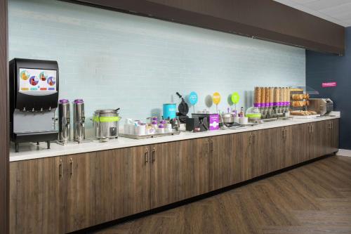 a kitchen with a counter with food and a tv at Tru By Hilton Denver Airport Tower Road in Denver