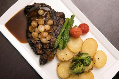 a plate of food with meat and vegetables on a table at DoubleTree by Hilton Dulles Airport-Sterling in Sterling