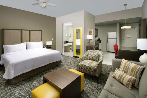 a bedroom with a bed and a living room at Homewood Suites by Hilton Miami Downtown/Brickell in Miami