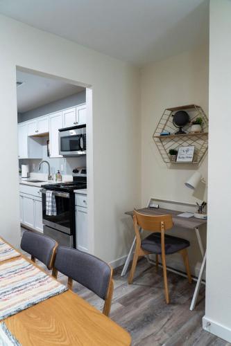 a kitchen with a table and chairs and a table and a kitchen with a counter at Madrona's Cottage B- Fully fenced and pet friendly in Charleston