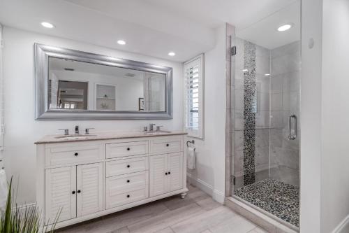 a white bathroom with a sink and a shower at La Contento Casa - 5560 in Siesta Key