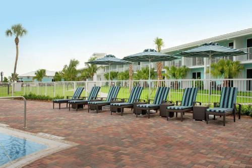a row of chairs with umbrellas next to a pool at Hampton Inn Marathon - Florida Keys in Marathon