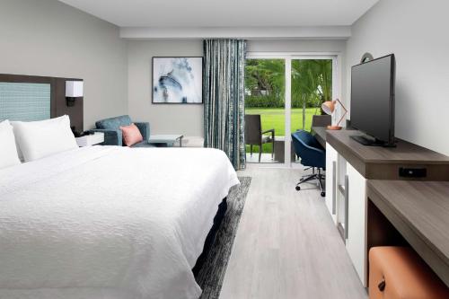 a hotel room with a bed and a tv at Hampton Inn Marathon - Florida Keys in Marathon