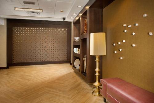 a living room with a couch and a lamp at Hampton Inn & Suites San Antonio-Downtown/Market Square in San Antonio
