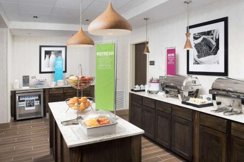 a kitchen with a counter with a bowl of fruit on it at Hampton Inn & Suites San Antonio Lackland AFB SeaWorld in San Antonio