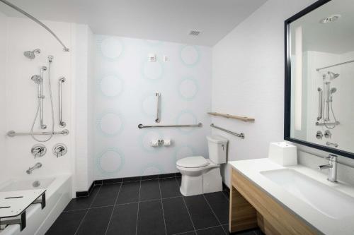 a bathroom with a toilet and a sink and a shower at Tru By Hilton San Antonio Lackland Sea World in San Antonio