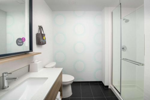a bathroom with a toilet and a glass shower at Tru By Hilton San Antonio Lackland Sea World in San Antonio