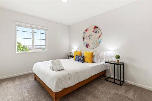 a white bedroom with a large bed and a window at Only available on other site in Sacramento