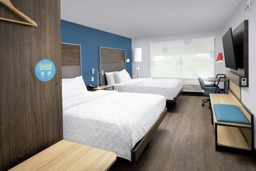 a hotel room with two beds and a tv at Tru By Hilton San Antonio Lackland Sea World in San Antonio