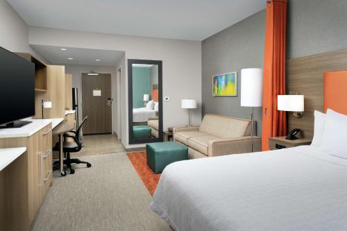 a hotel room with a bed and a desk at Home2 Suites By Hilton Asheville Biltmore Village in Asheville