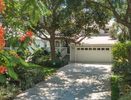a house with a tree and a garage at Isla Amor - 86 in Siesta Key