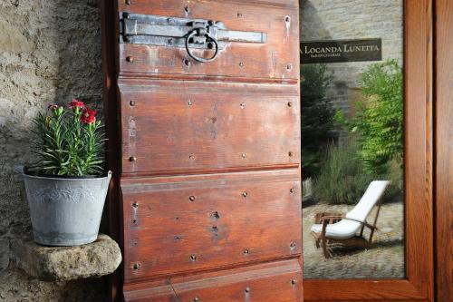a wooden door with a potted plant on it at Antica Locanda Lunetta in Màndas