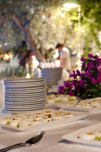 a table with plates of food on it with flowers at Agriturismo Giorgio in Mattinata
