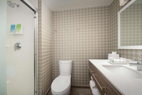 a bathroom with a toilet and a sink and a shower at Home2 Suites By Hilton Edison in Edison
