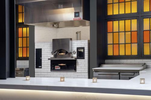 a kitchen with a pizza oven in a room at Canopy By Hilton Ithaca Downtown in Ithaca