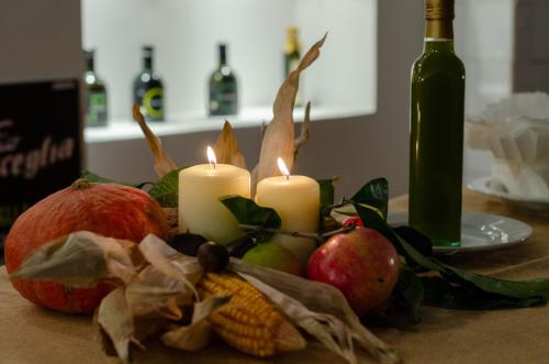 a table with candles and fruit and a bottle of wine at Agriturismo Giorgio in Mattinata