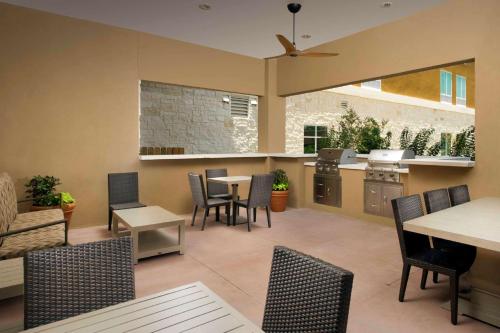 a kitchen and dining room with tables and chairs at Homewood Suites San Antonio Airport in San Antonio