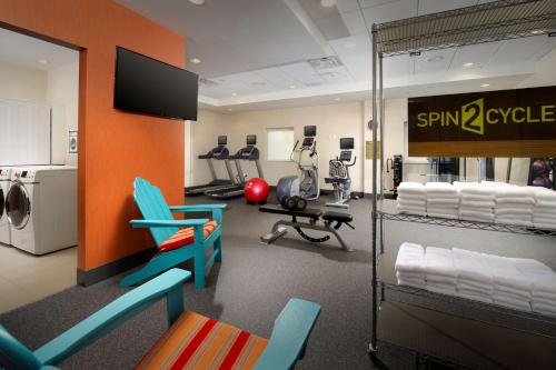 a fitness room with a gym with chairs and machines at Home2 Suites by Hilton Arundel Mills BWI Airport in Hanover