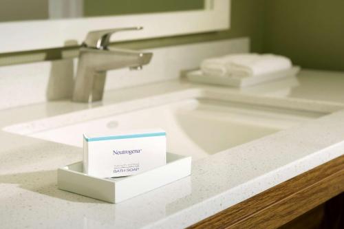 a bathroom counter with a sink with a box on it at Home2 Suites by Hilton Arundel Mills BWI Airport in Hanover