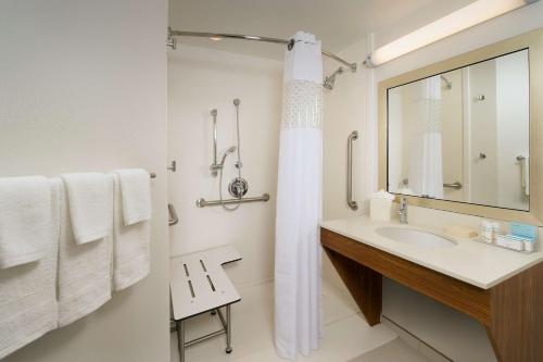 a white bathroom with a sink and a mirror at Hampton Inn & Suites San Antonio Northwest/Medical Center in San Antonio