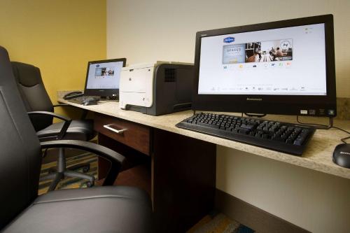 a desk with a computer and a printer on it at Hampton Inn & Suites Syracuse/Carrier Circle in East Syracuse
