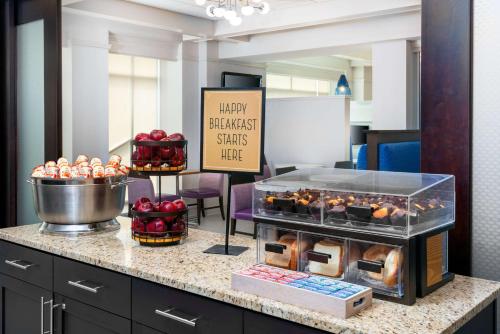 a display of muffins and other pastries on a counter at Hampton Inn & Suites Buffalo/Downtown in Buffalo