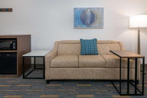 a living room with a couch and two tables at Hampton Inn & Suites Buffalo/Downtown in Buffalo