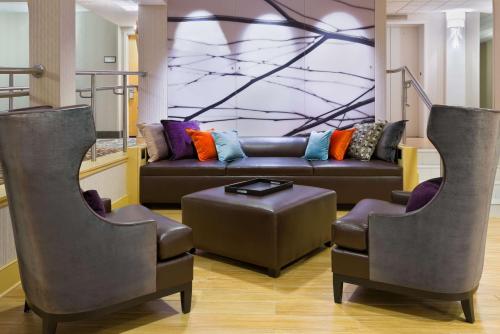 a living room with a couch and two chairs at Hampton Inn Danbury in Danbury