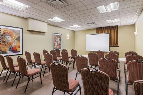 a conference room with chairs and a white screen at Hampton Inn Danbury in Danbury