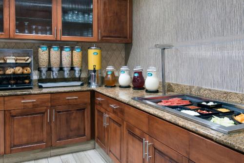 a kitchen with a counter top with a bunch of food at Homewood Suites by Hilton Cleveland-Beachwood in Beachwood