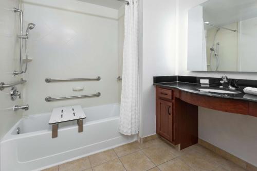 a bathroom with a tub and a sink and a shower at Homewood Suites by Hilton Cleveland-Beachwood in Beachwood