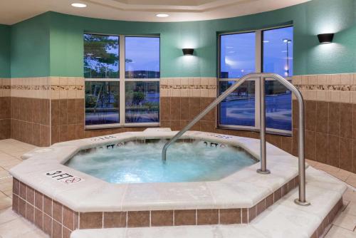 a jacuzzi tub in a room with windows at Homewood Suites by Hilton Cleveland-Beachwood in Beachwood