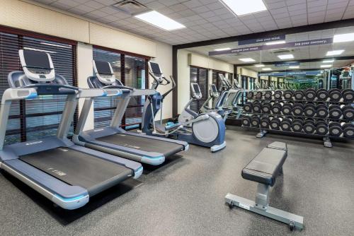 a gym with rows of treadmills and machines at Hampton Inn Springfield South Enfield in Enfield