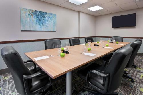 a conference room with a large wooden table and chairs at Hampton Inn South Plainfield-Piscataway in South Plainfield