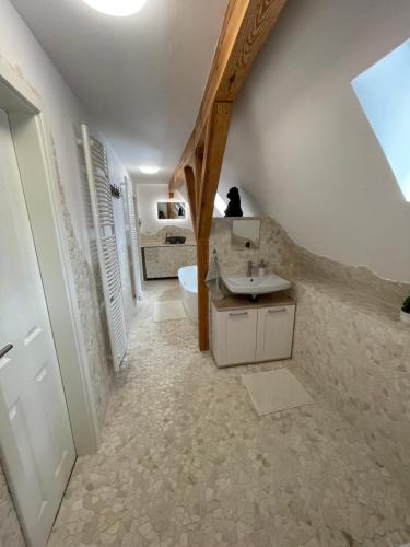 an attic bathroom with a sink and a toilet at Ferienhaus Weise in Alt Töplitz