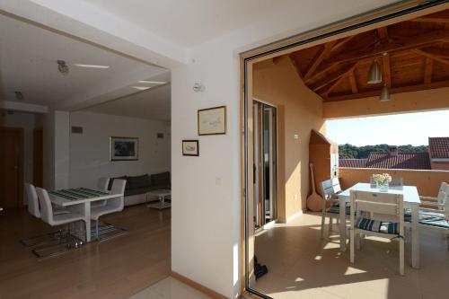 a living room and dining room with a table and chairs at Apartment Mara in Petrcane