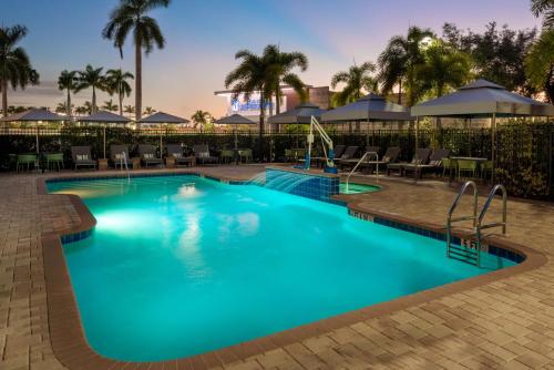 a pool at a resort with tables and chairs at Hampton Inn and Suites Sarasota/Lakewood Ranch in Sarasota