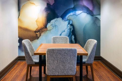 a table and chairs in a room with a mural at Hampton Inn and Suites Sarasota/Lakewood Ranch in Sarasota